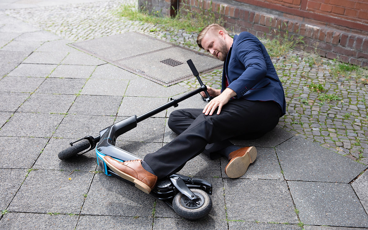 man on the ground after scooter accident