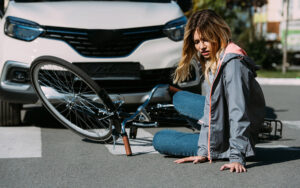 woman on the floor after bicycle accident